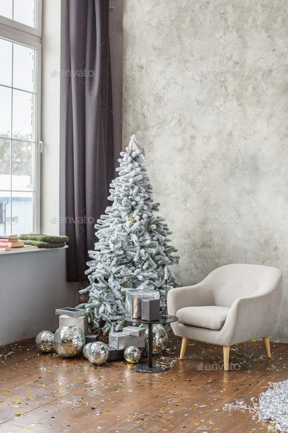 Room interior with Christmas tree, gray chair and gift boxes. Window